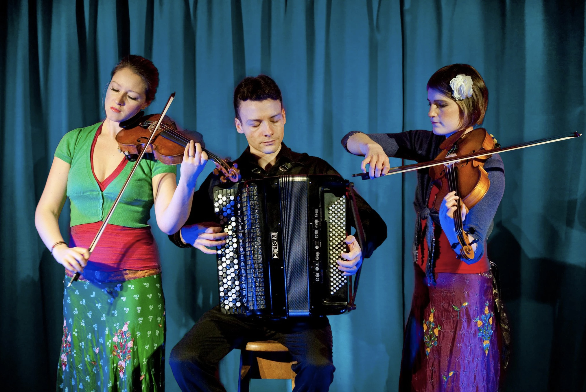 three people playing instruments