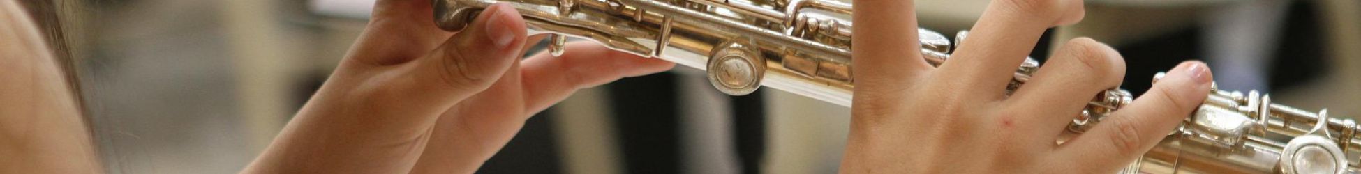 close up of hands whilst person playing the flute